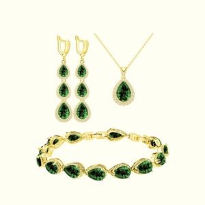 Emerald and Gold jewelry set including earrings, bracelet, and a necklace.